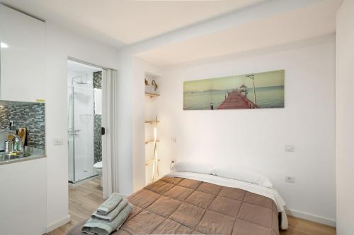 a bedroom with white walls and a bed in a room at Casa Paula - 13 in Arinaga
