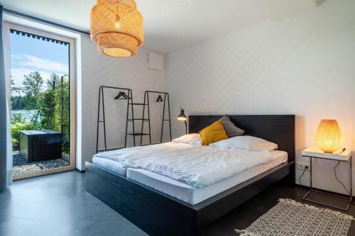 a bedroom with a bed and a large window at La casa nel verde in Lindau