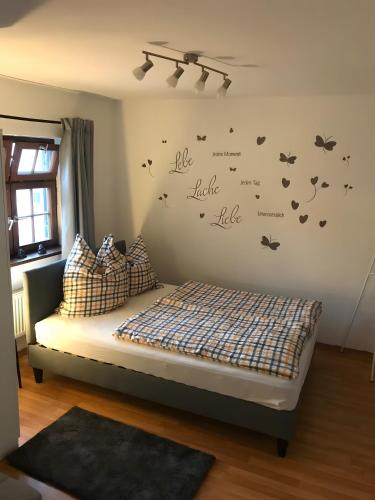 a bedroom with a bed with butterflies on the wall at Ulmer Spatzennest in Ulm