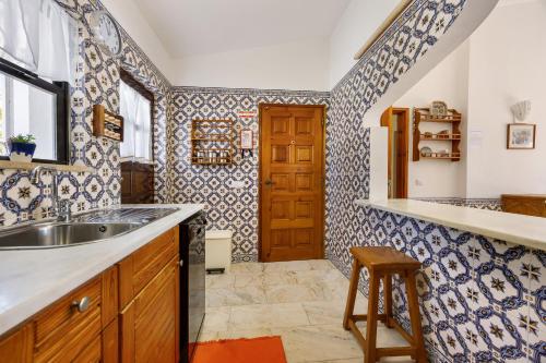 a kitchen with a sink and a wooden door at Casa 54 in Valverde