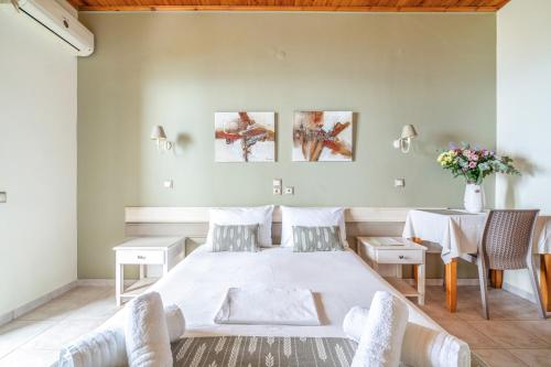a bedroom with a large bed and a table at Nontas Homes 32 in Kalamitsi