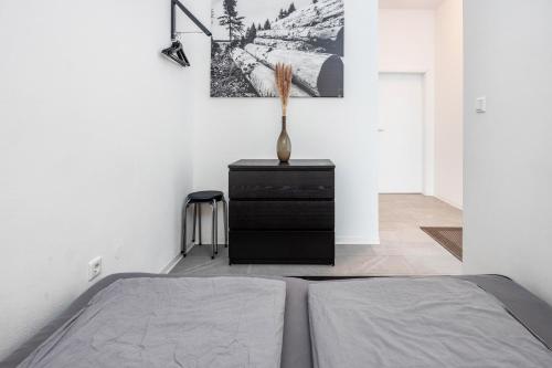 a bedroom with a bed and a vase on a dresser at Altenbeken- Ferienwohnung 1 in Altenbeken