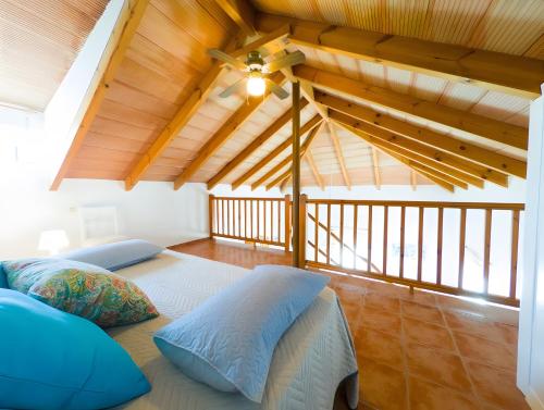 a bedroom with two beds in a room with wooden ceilings at Casas Pepe 5 Bungalow in Los Caños de Meca