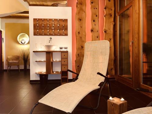 a bathroom with a chair and a sink at Residence Zirmer in Castelrotto