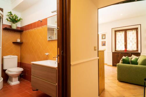 a bathroom with a toilet and a sink at Casa Carly Taormina in Taormina