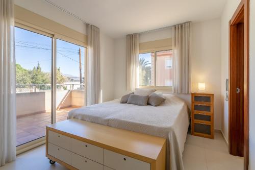 a bedroom with a bed and a large window at Villa Mina - First Line Villa in El Campello