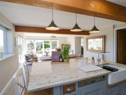 a kitchen with a large island with a counter top at Barn Howe in Kendal