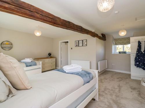 a bedroom with two beds in a room at Barn Howe in Kendal