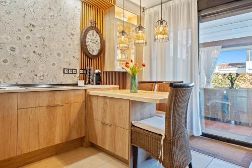 a kitchen with a counter and a clock on the wall at Casa Emi in Cambrils