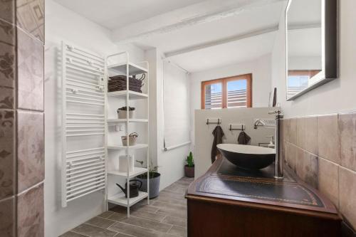 a bathroom with a sink and a mirror at Maison de ville Fréjus in Fréjus