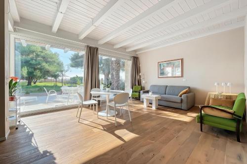a living room with a table and chairs and a couch at Villa Traimari in Trani