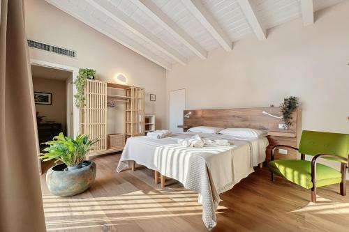a bedroom with two beds and two chairs at Villa Traimari in Trani