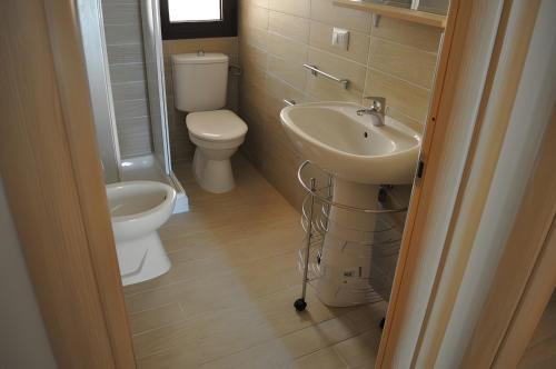 a bathroom with a toilet and a sink at Casa vacanza La Rosa dei Venti in Viddalba