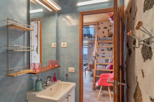 a bathroom with a sink and a mirror and a ladder at Finca El Tablero in Tinajo