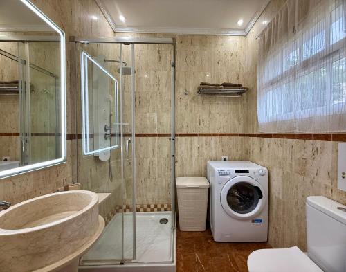 a bathroom with a sink and a washing machine at Villa Tequila in Adeje