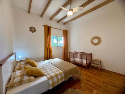 a bedroom with a bed and a window and a crib at Villa Tequila in Adeje