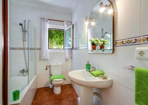 a bathroom with a sink and a toilet and a shower at Casa Dos Mas in Cala en Porter