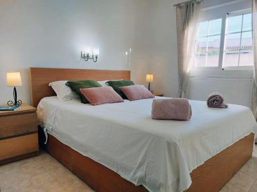 a bedroom with a large bed with two pillows on it at Casa Dos Mas in Cala en Porter