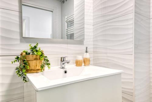 a white bathroom with a sink and a mirror at Calpe Beach in Calpe