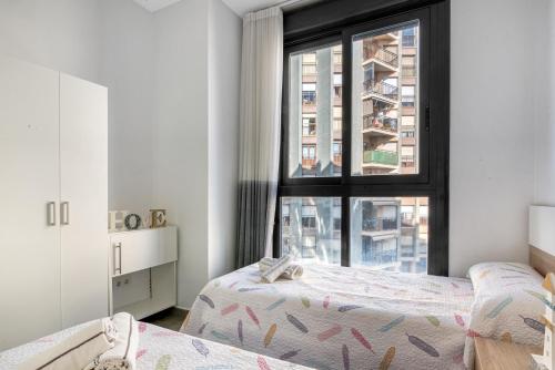 a bedroom with two beds and a window at Calpe Beach in Calpe
