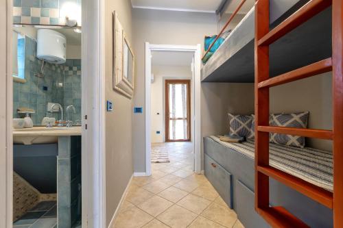 a bathroom with a bunk bed and a sink at Casa Fiamma in Stintino