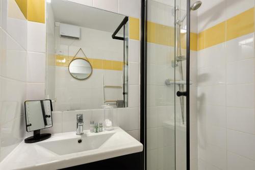 a bathroom with a sink and a shower at Appartement Bielle 106 in Bielle