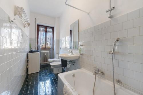 a bathroom with a tub and a sink and a toilet at La terrazza sull’Adda in Malgrate