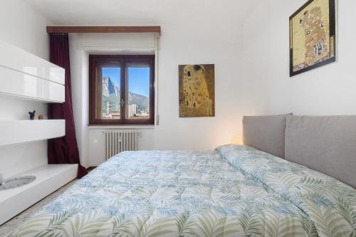 a bedroom with a bed and a window at La terrazza sull’Adda in Malgrate