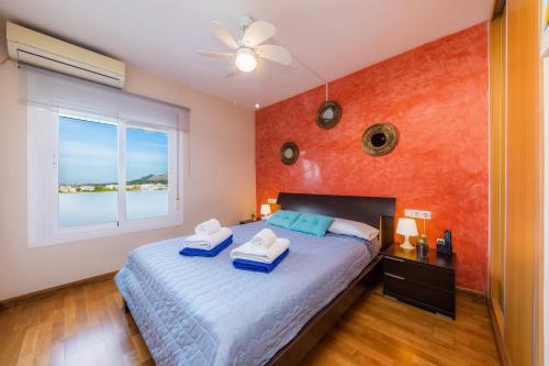 a bedroom with a bed with two towels on it at Sweet Sea in Port d'Alcudia