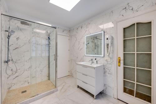 a white bathroom with a shower and a sink at Villa Marbella -pool - Beach At 300 in Marbella