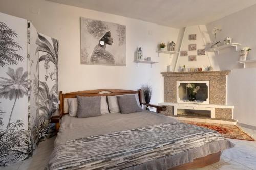 a bedroom with a bed and a fireplace at La casetta Bianca in Sassari