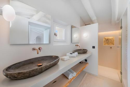 a bathroom with two sinks and a large stone sink at Can Mas Villa Antigua in Pollença