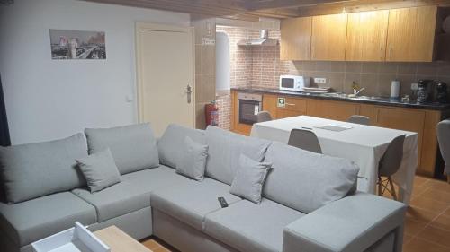 a living room with a couch and a kitchen at Casa do Avô Almeida in Lajes das Flores