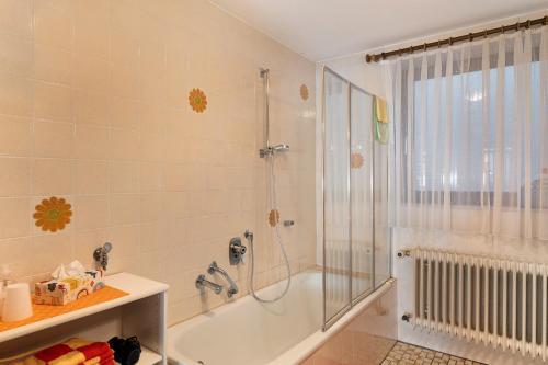 a bathroom with a shower and a bath tub at Haus Schindler in Ottenhöfen
