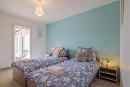 a bedroom with two beds and a window at Villa M Vallon Pont d'arc in Vallon-Pont-dʼArc