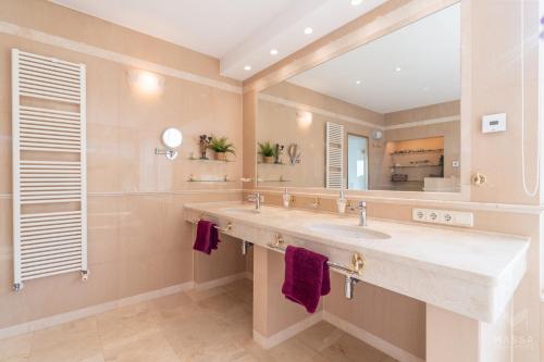 a bathroom with a large sink and a mirror at Finca Assindia, Costa de los Pinos in Son Servera