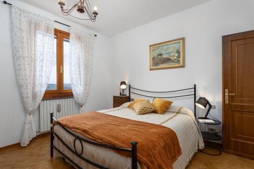 a bedroom with a bed and a window at Podere Sasso 3 in San Gimignano