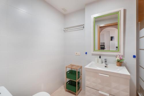 a white bathroom with a sink and a mirror at Sandra La Perla in El Médano