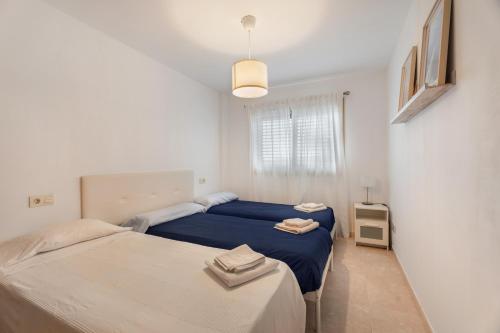 a bedroom with two beds and a window at Sandra La Perla in El Médano