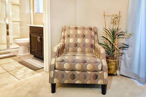 a chair sitting in a bathroom with a toilet at Spacious Desert Suite Minutes to Phoenix Fun - Pet Friendly! in Avondale