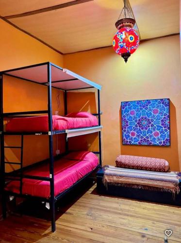 a bedroom with two bunk beds and a chandelier at Prisamata in Salta