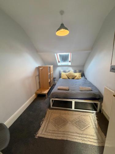 a small room with a bed in a attic at Central location location in Hollington