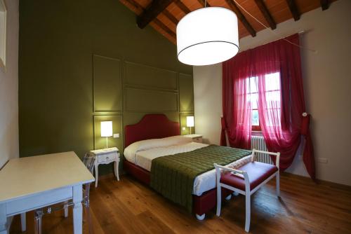 a bedroom with a bed and a table and a window at Casanova in Scandicci