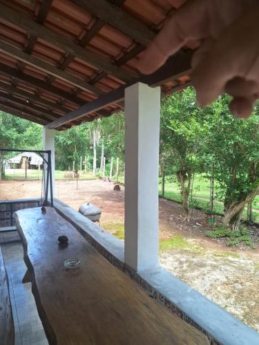 a view from the inside of a porch with a wooden table at Fazenda São Leandro in Rio das Flores