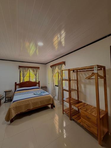 a bedroom with a bed and a ladder in it at Casa Osa Azul in Puerto Jiménez