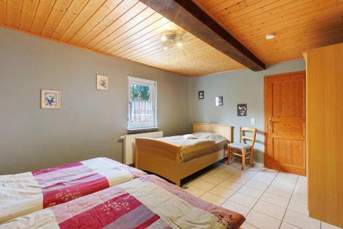 a bedroom with two beds and a wooden ceiling at Scholz in Sannerz