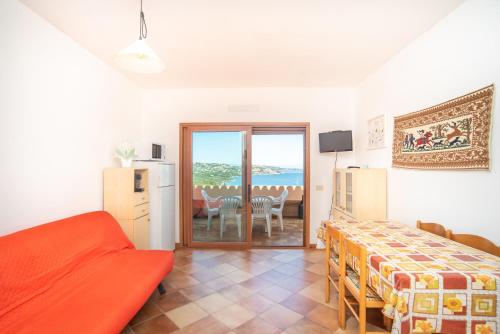 a bedroom with a bed and a dining room with a table at Flat Orizzonte in Palau