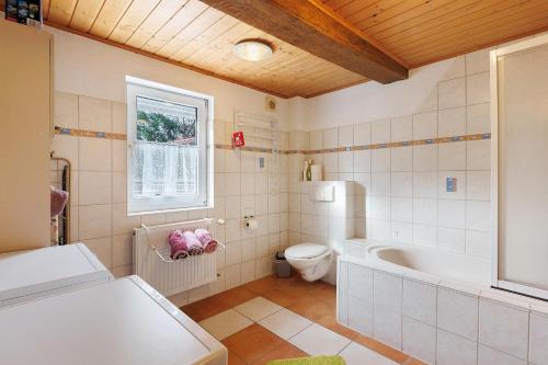 a bathroom with a tub and a toilet and a sink at Scholz in Sannerz
