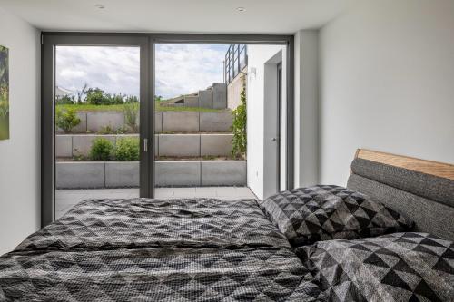 a bedroom with a bed in front of a window at Ferienwohnung im Obstgarten in Ihringen