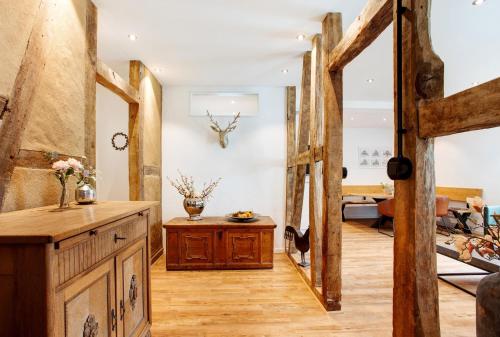a living room with wooden floors and a wooden table at Gut Vasbach Ferienwohnungen in Kirchhundem